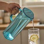 BY-9166 unbreakable PC full-handle water pitcher (blue) - being poured by hand