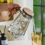 BY-9183B unbreakable PC full-handle water pitcher (gray) - being poured by hand