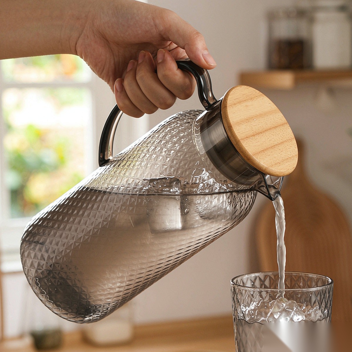 BY-9190A unbreakable PC full-handle water pitcher (gray) - being poured by hand