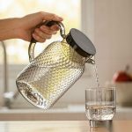 BY-9190C unbreakable PC full-handle water pitcher (gray) - being poured by hand