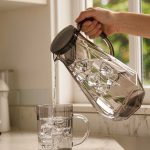 BY-9192A unbreakable PC full-handle water pitcher (gray) - being poured by hand