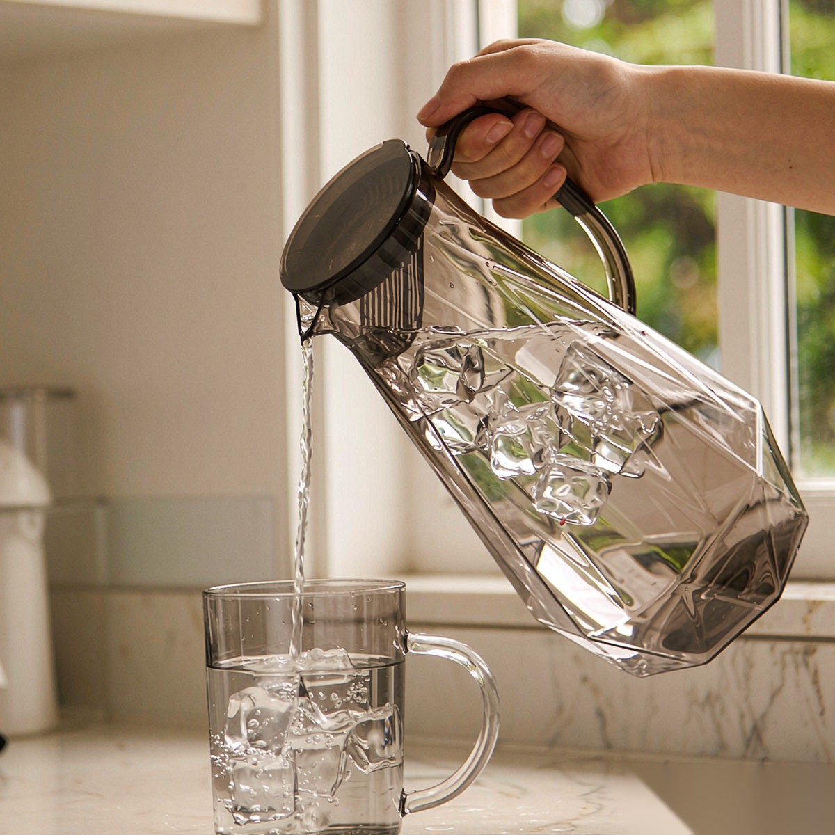 BY-9192A unbreakable PC full-handle water pitcher (gray) - being poured by hand