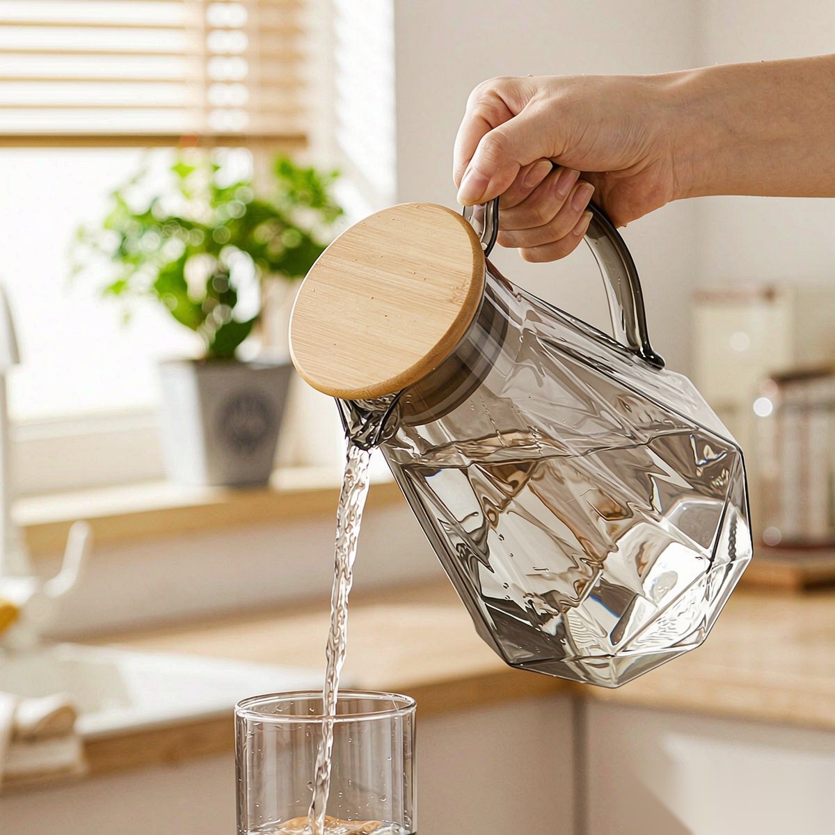 BY-9192B unbreakable PC full-handle water pitcher (gray) - being poured by hand