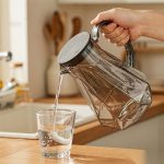 BY-9192C unbreakable PC full-handle water pitcher (gray) - being poured by hand