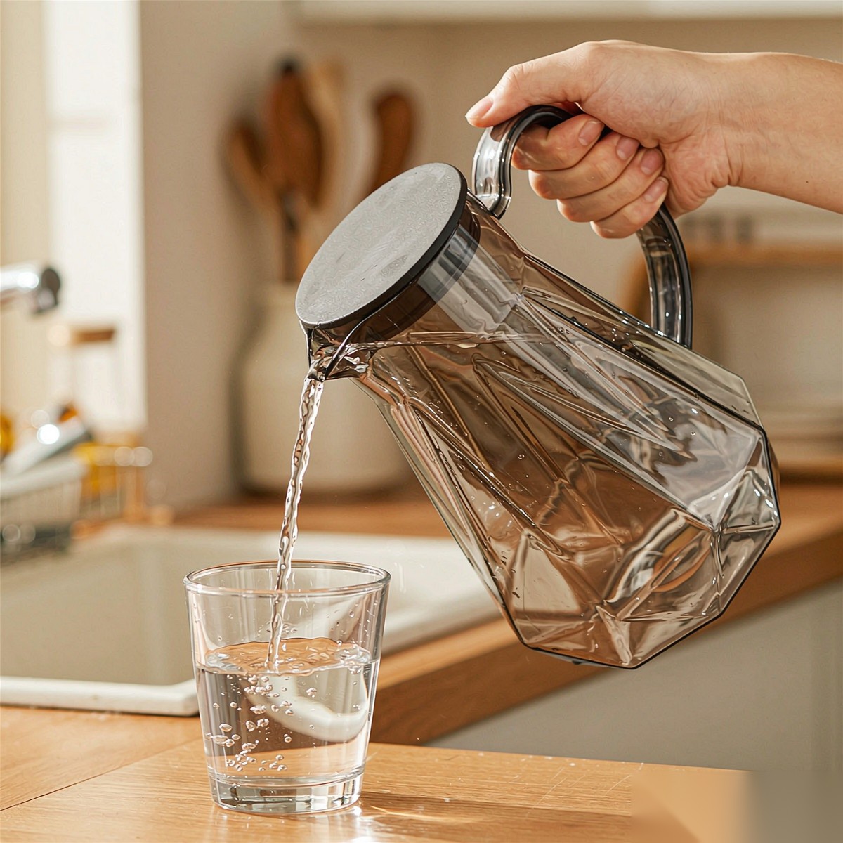 BY-9192C unbreakable PC full-handle water pitcher (gray) - being poured by hand