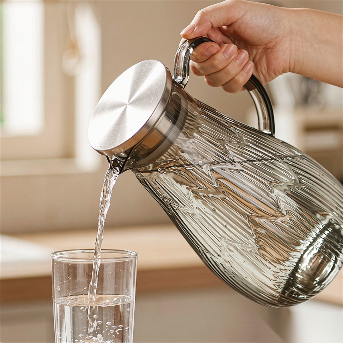 BY-9193A unbreakable PC full-handle water pitcher (gray) - being poured by hand