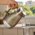 BY-9193B unbreakable PC full-handle water pitcher (gray) - being poured by hand