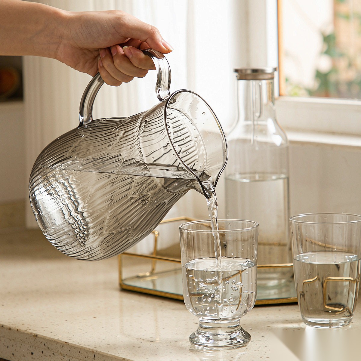 BY-9193C unbreakable PC full-handle water pitcher (gray) - being poured by hand