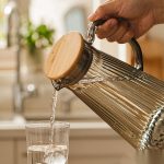 BY-9194A unbreakable PC full-handle water pitcher (gray) - being poured by hand