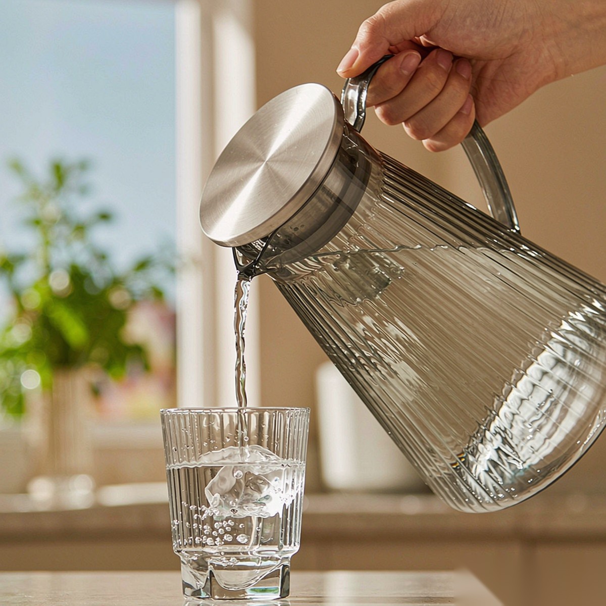 BY-9194B unbreakable PC full-handle water pitcher (gray) - being poured by hand