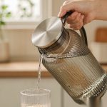 BY-9195A unbreakable PC full-handle water pitcher (gray) - being poured by hand