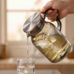 BY-9195C unbreakable PC full-handle water pitcher (gray) - being poured by hand