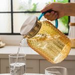 BY-9196A unbreakable PC full-handle water pitcher (tea) - being poured by hand
