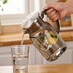 BY-9198C unbreakable PC full-handle water pitcher (gray) - being poured by hand