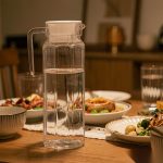 BY-9144B unbreakable PC stainless steel handle water pitcher - set on a dining table for dinner