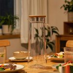 BY-9160A unbreakable PC stainless steel handle water pitcher (gray) - set on a dining table for dinner
