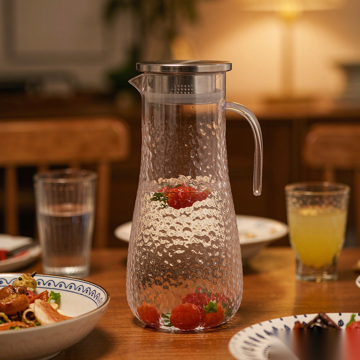 BY-9164 unbreakable PC stainless steel handle water pitcher (steel) - set on a dining table for dinner